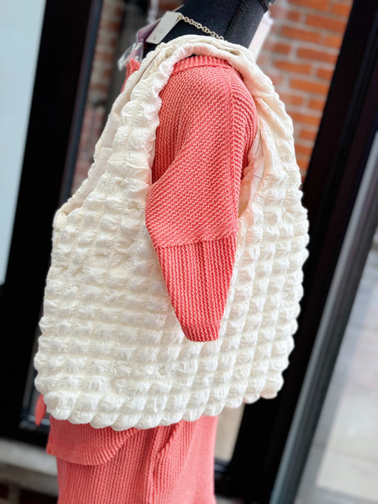 white/pink puffer bag