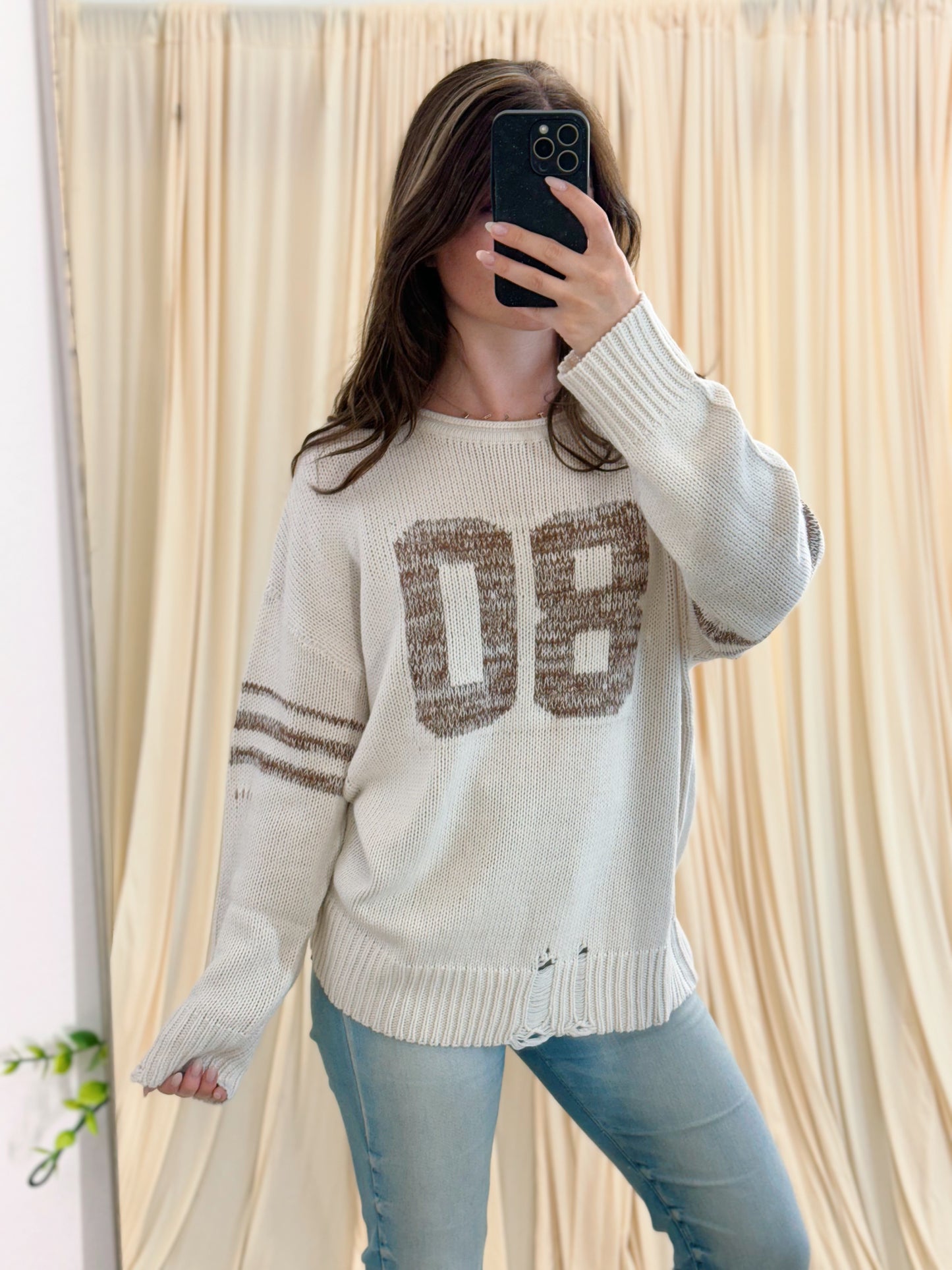distressed varsity sweater